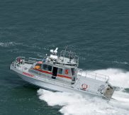 A modern fireboat moving at speed.